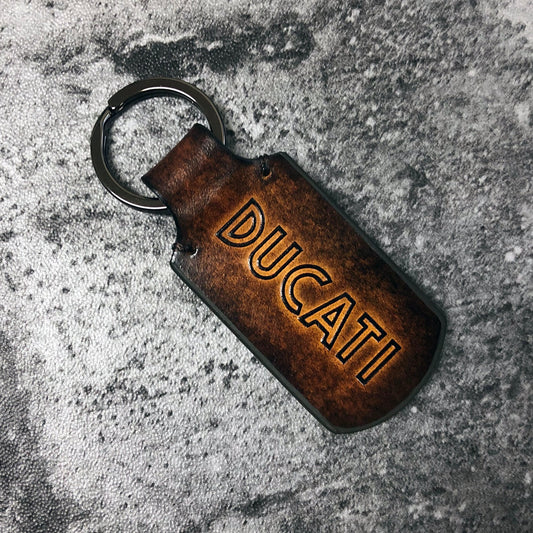 Embossed Ducati Classic font, Leather keychain in Brown. Customizable