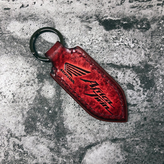 Wing symbol and Africa Twin is embossed, handmade motorcycle Leather keychain in Red(Pointed shape)