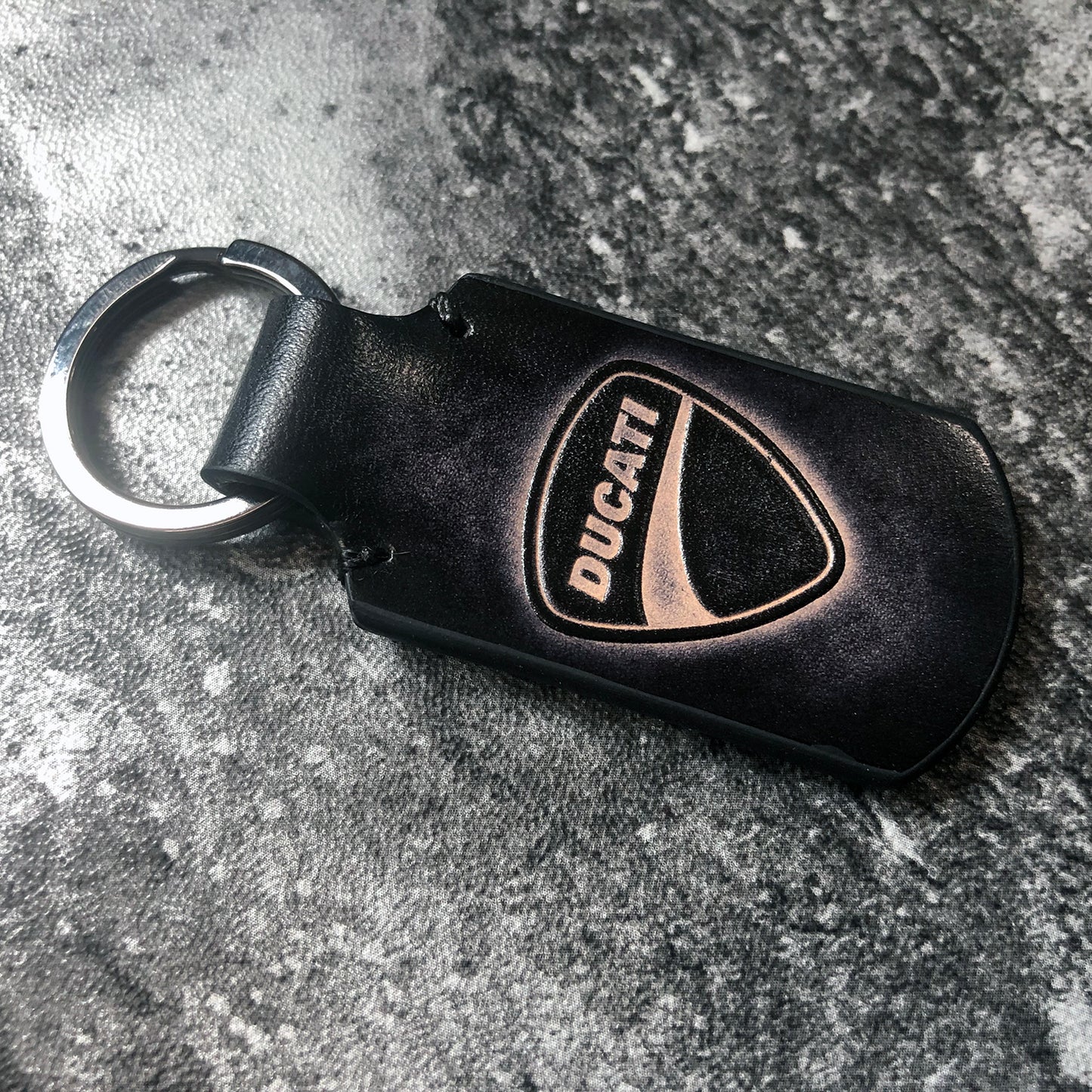 Ducati symbol embossed, vintage Leather keychain in Black. Customizable